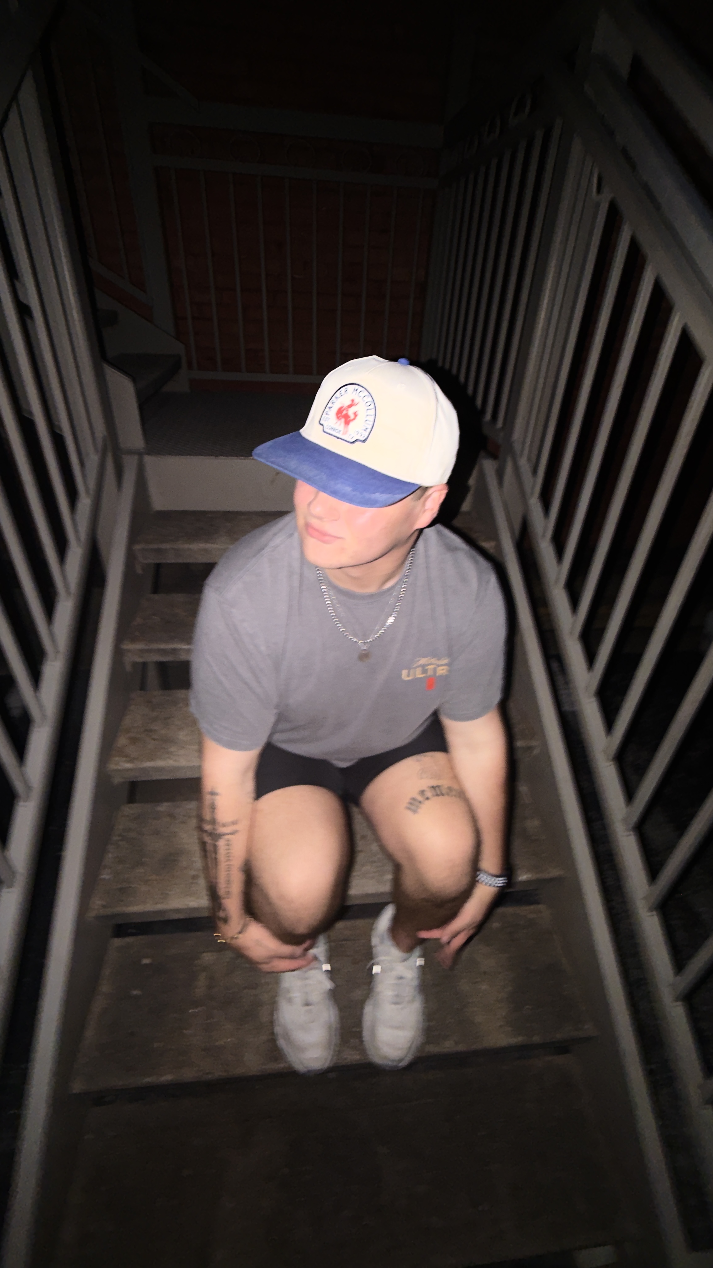 Duncan sitting on a stairway at night